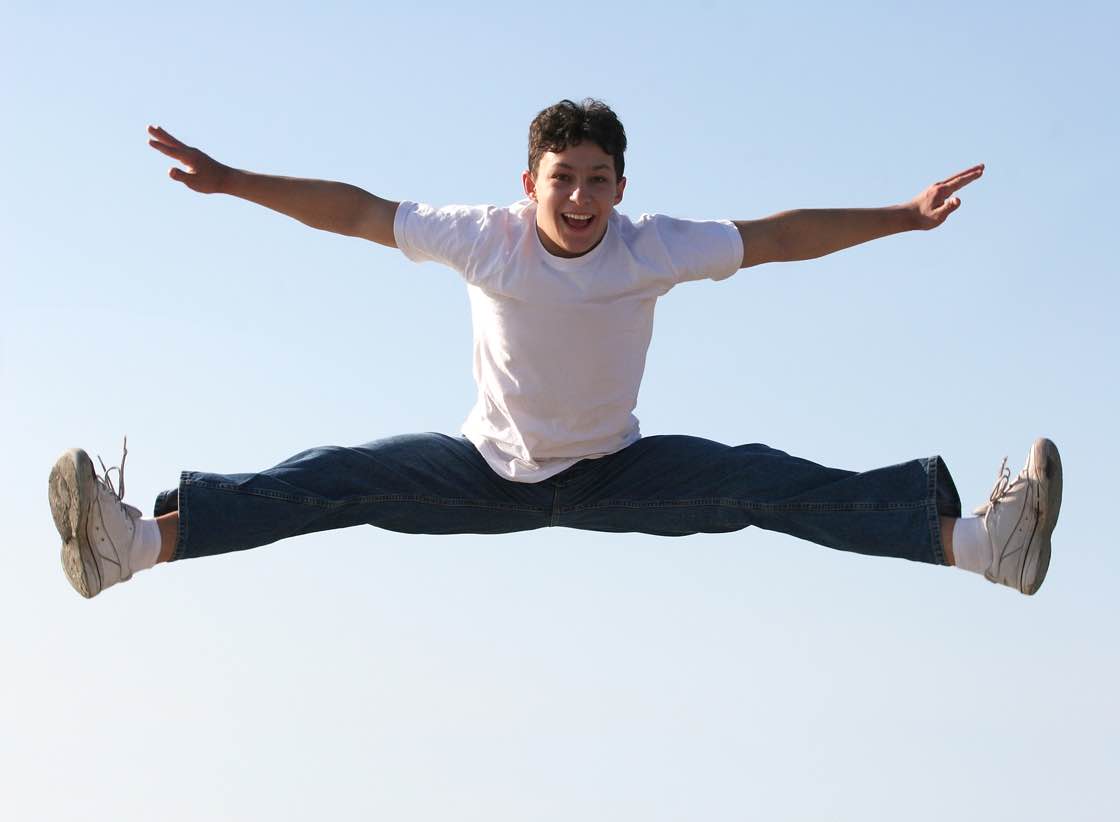 Boy making a split high in the air